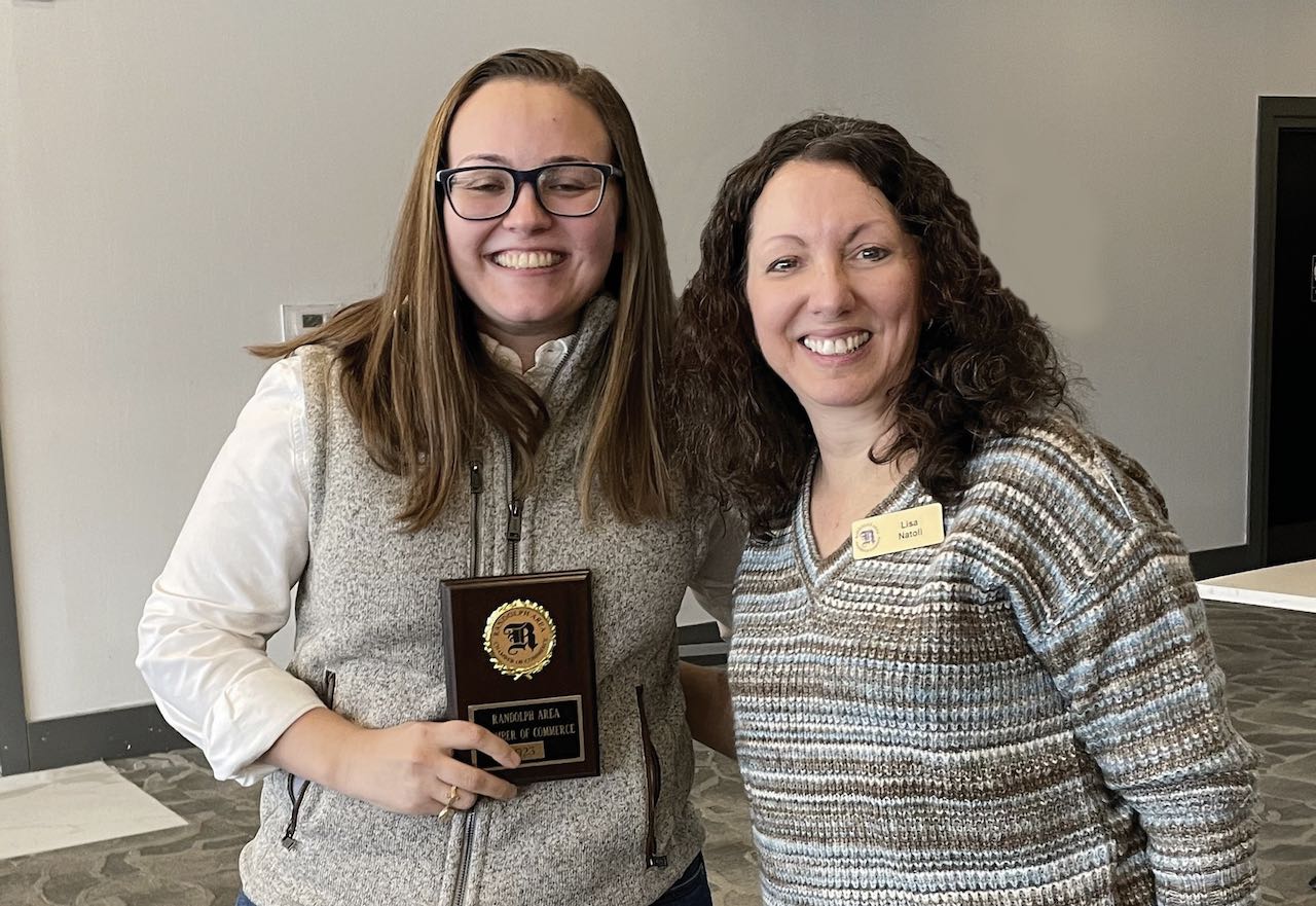 Woman receiving an award from another woman.